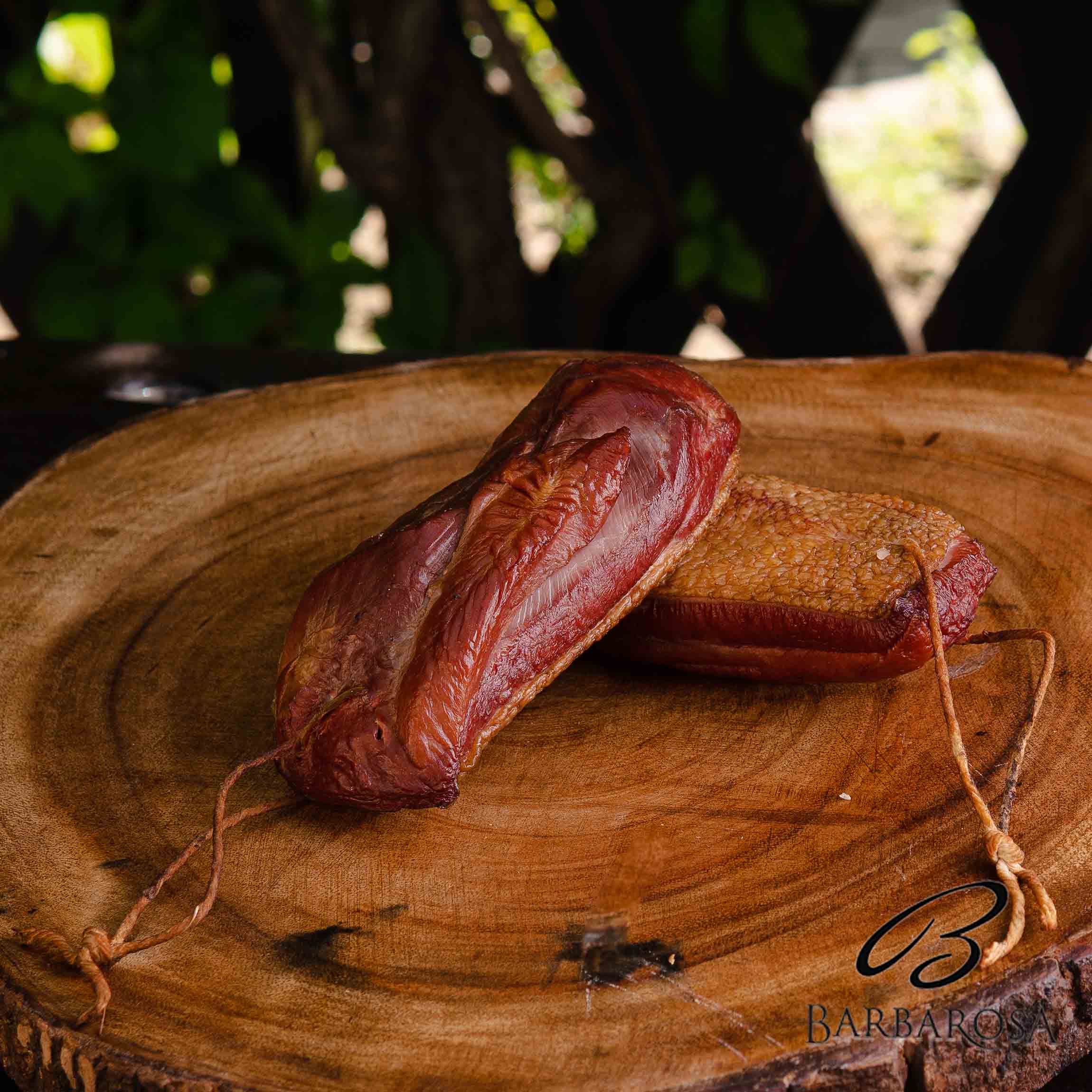 smoked duck fillet on a wooden board close-up