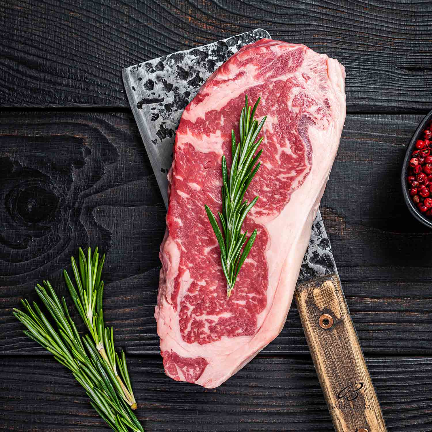 Fresh Raw new york strip beef steak on a butcher meat cleaver. B